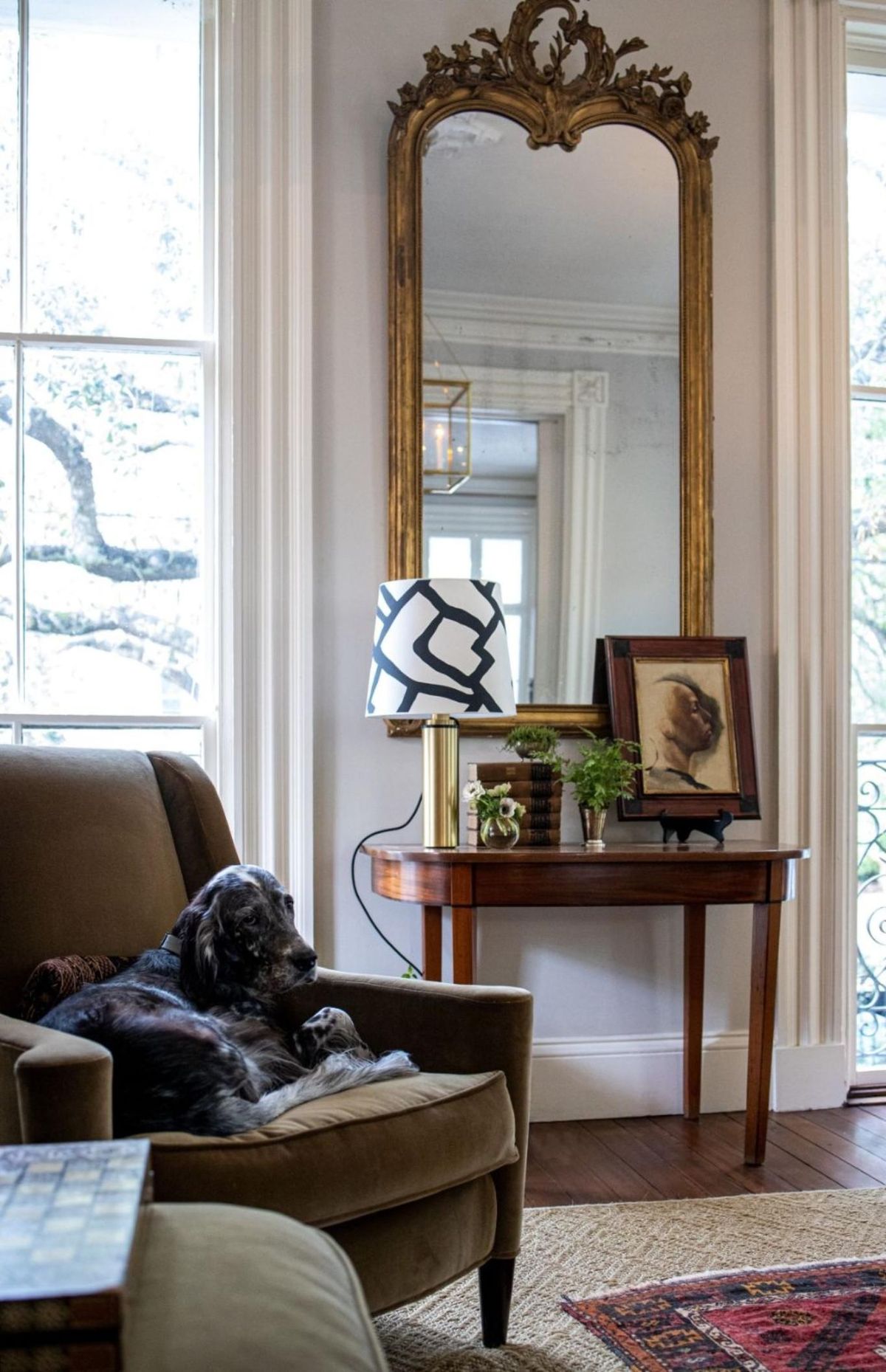 Salón elegante con espejo barroco.