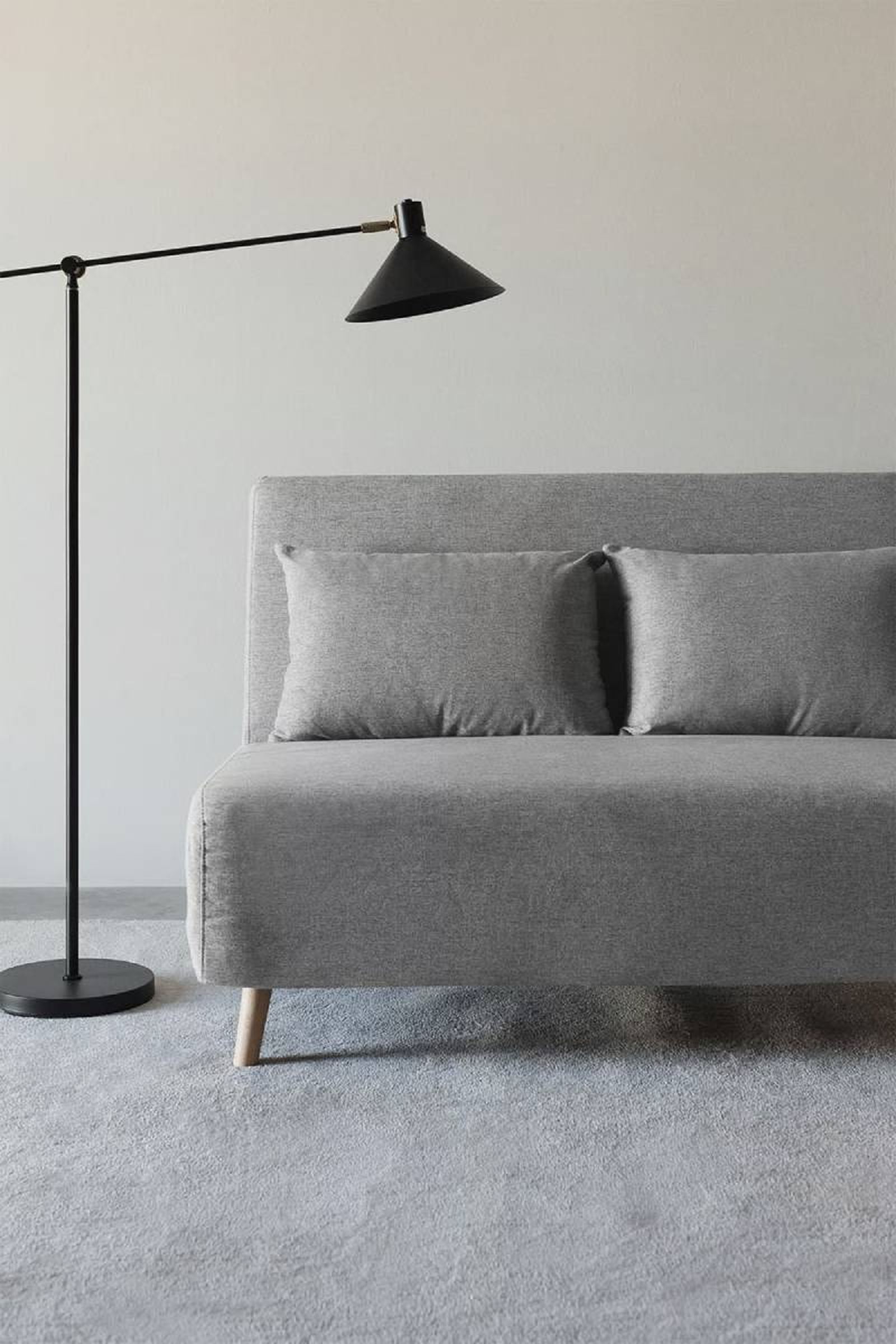 Sofá cama Elen de tela gris.