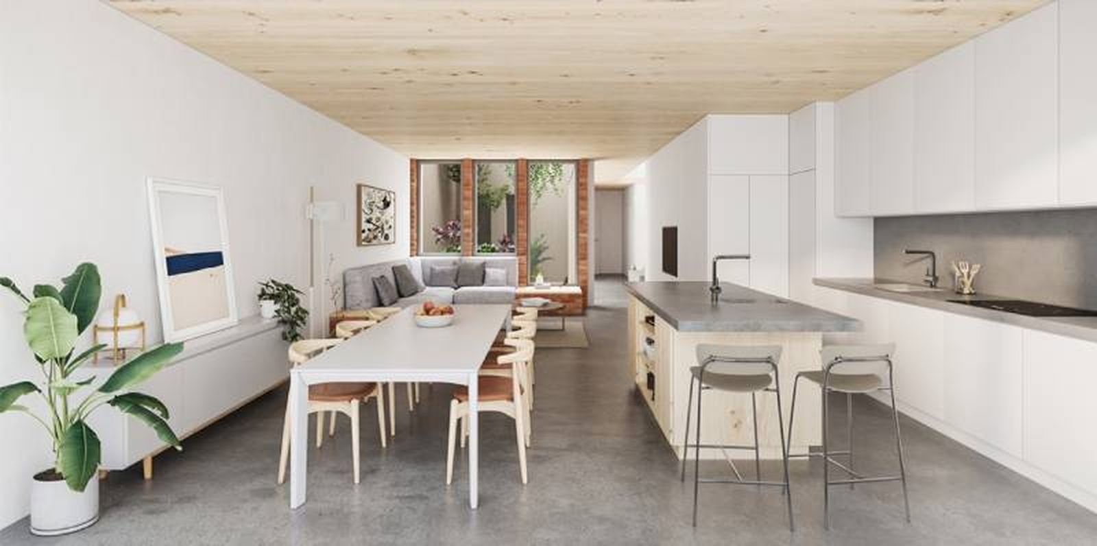 Cocina abierta al salón comedor de una casa entre medianeras.