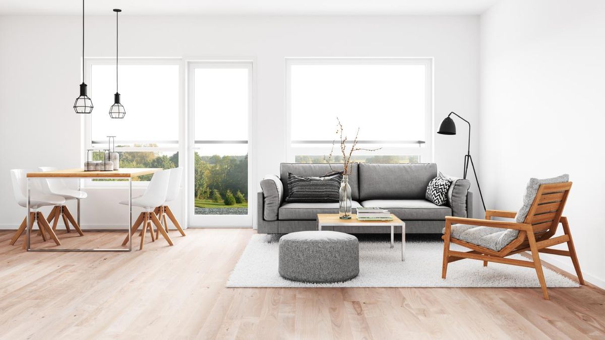 Salón comedor minimalista con lámparas industriales y geométricas.