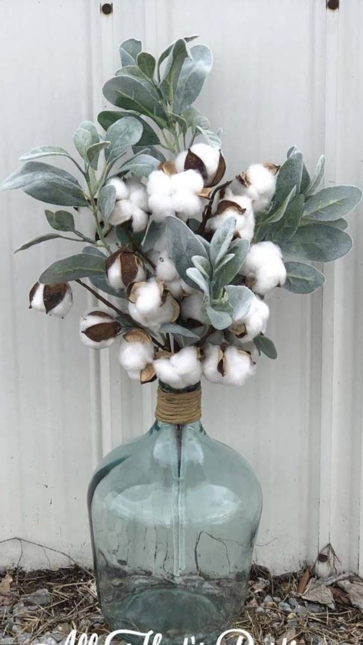 Damajuana decorada con flores de algodón.