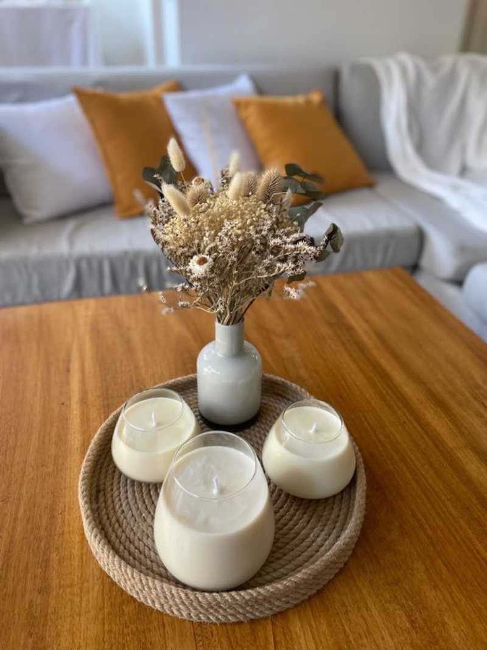 Centro de mesa con flores secas y velas perfumadas.