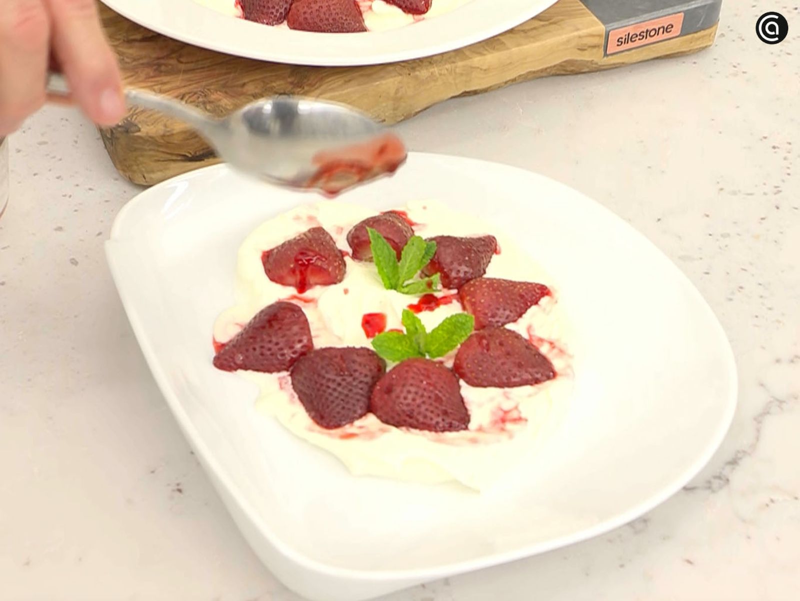 Sirve las fresas asadas sobre la crema de nata y queso