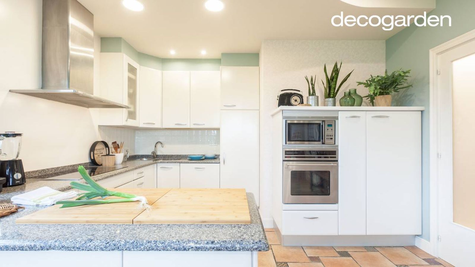 Cocina con los armarios pintados de blanco.