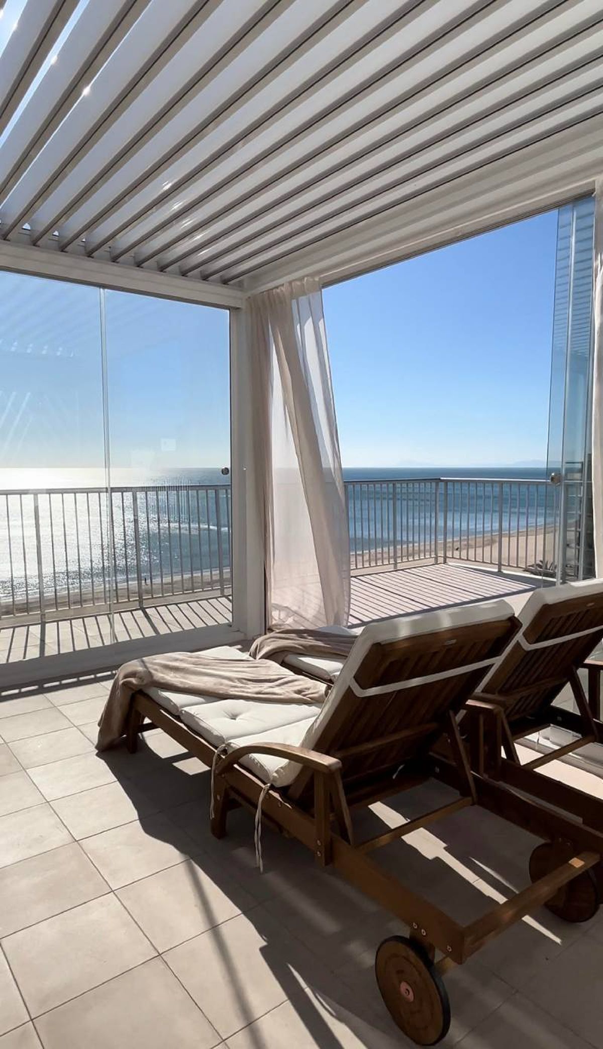 Terraza de Oasis Home Valencia con vistas al mar.