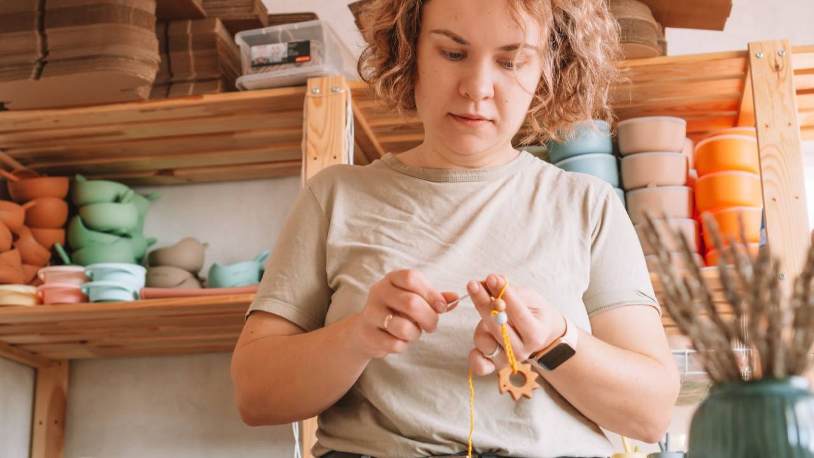 Mujer haciendo un nudo en un collar.