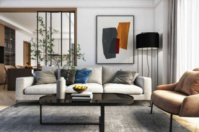 Salón moderno y elegante con decoración en beige y un cuadro abstracto.