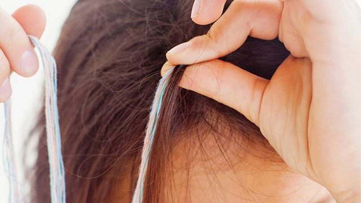 Segundo paso hacer las trenzas de hilo en el pelo