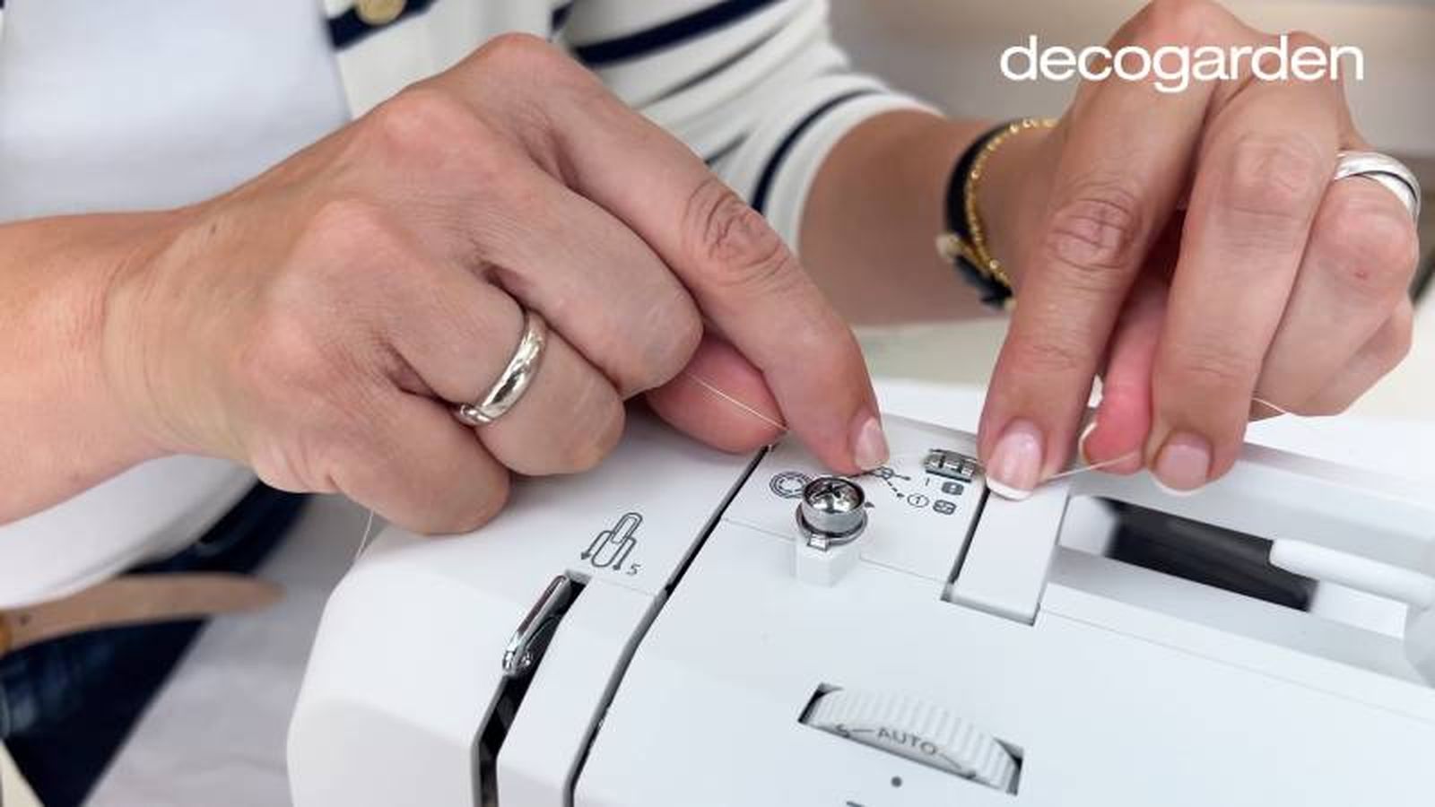 Enhebrar la aguja siguiendo las instrucciones de la máquina de coser.