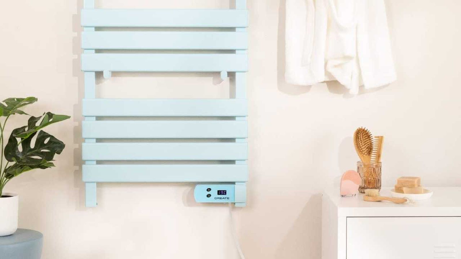 Baño con calientatoallas de pared azul.