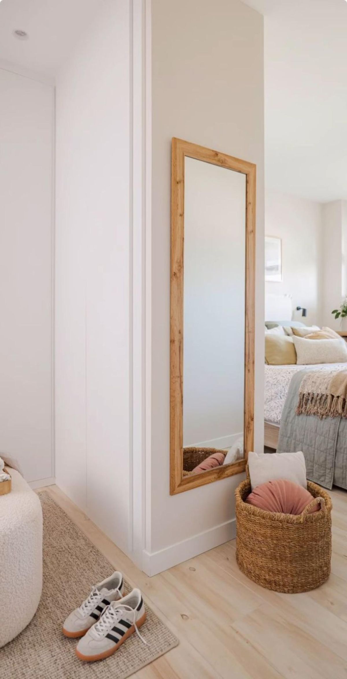 Espejo rectangular en la pared para ganar amplitud.