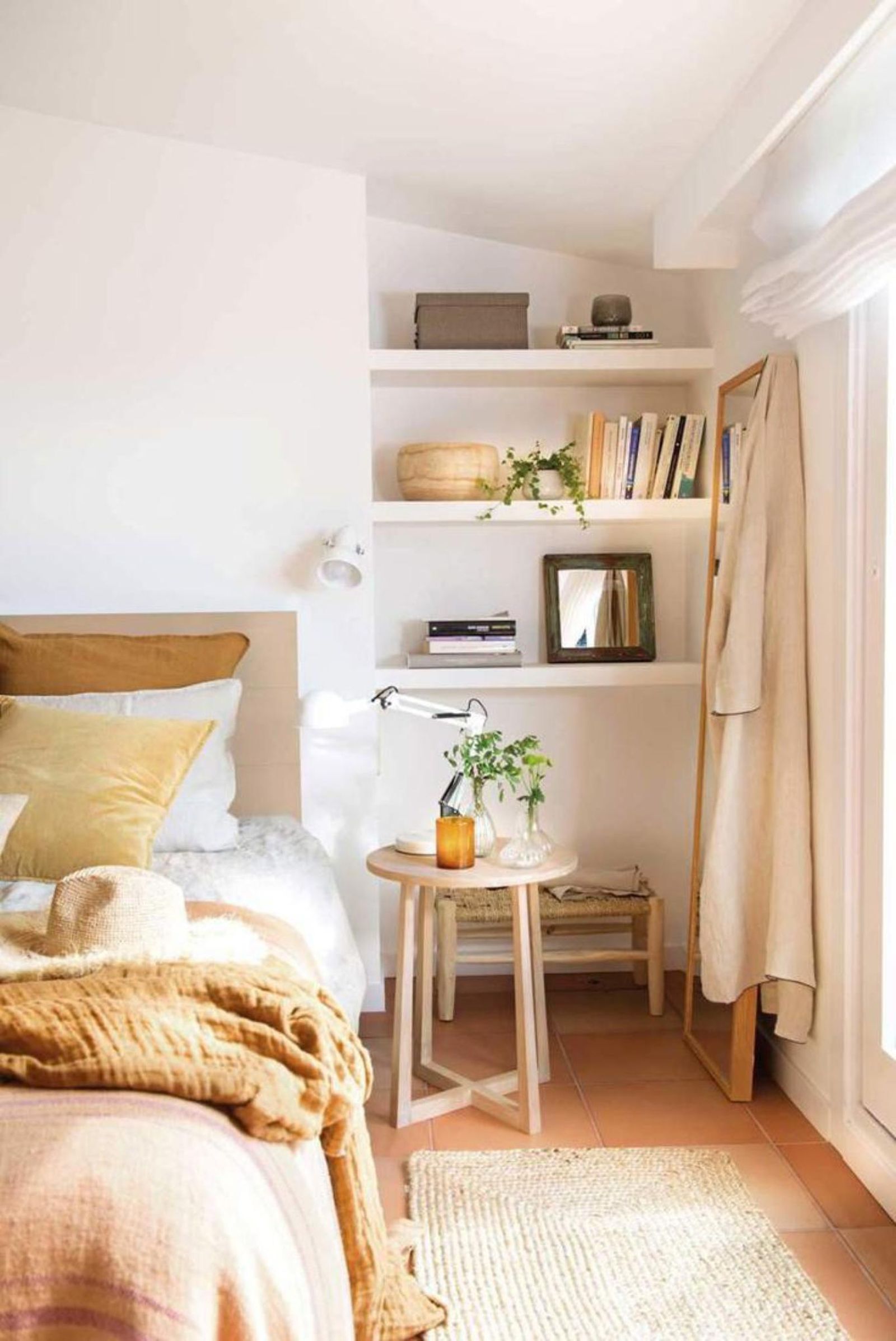 Dormitorio luminoso con aplique de pared.