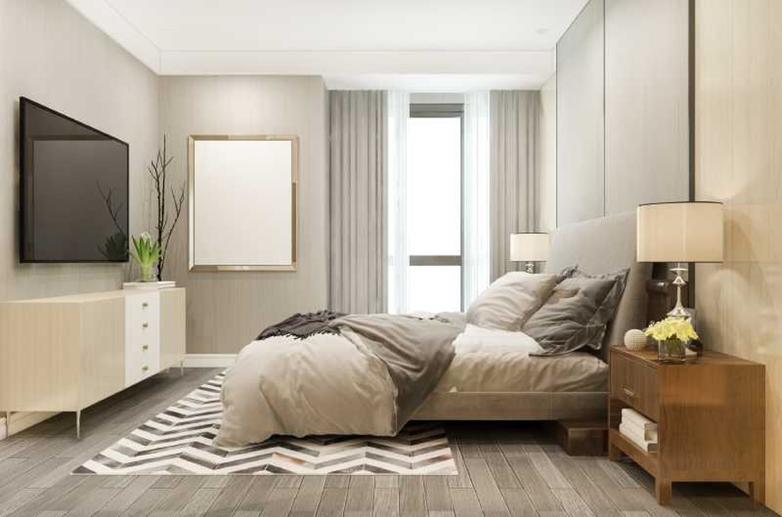 Dormitorio pequeño con alfombra a los pies de la cama.