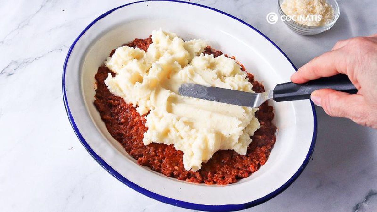 Agregamos el puré de patatas sobre la carne con tomate
