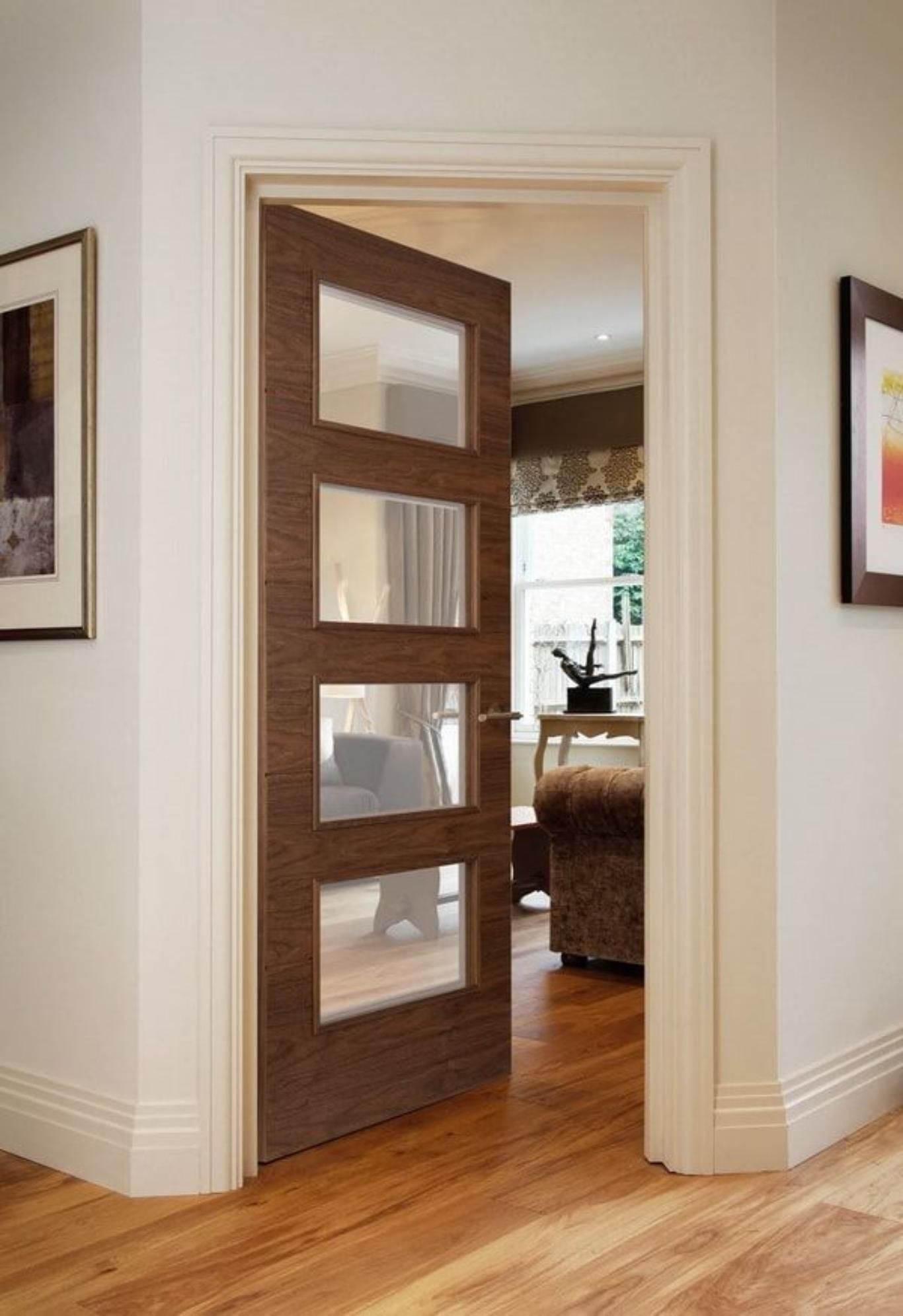 Salón con puertas de madera oscura y suelo claro.