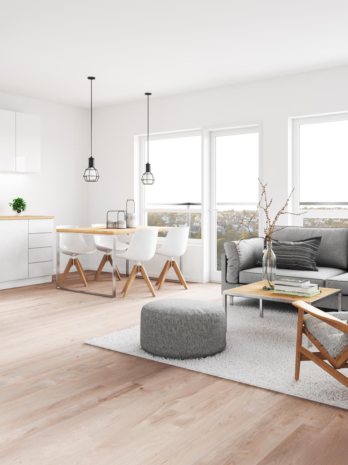 Salón comedor minimalista con lámparas geométricas colgantes.