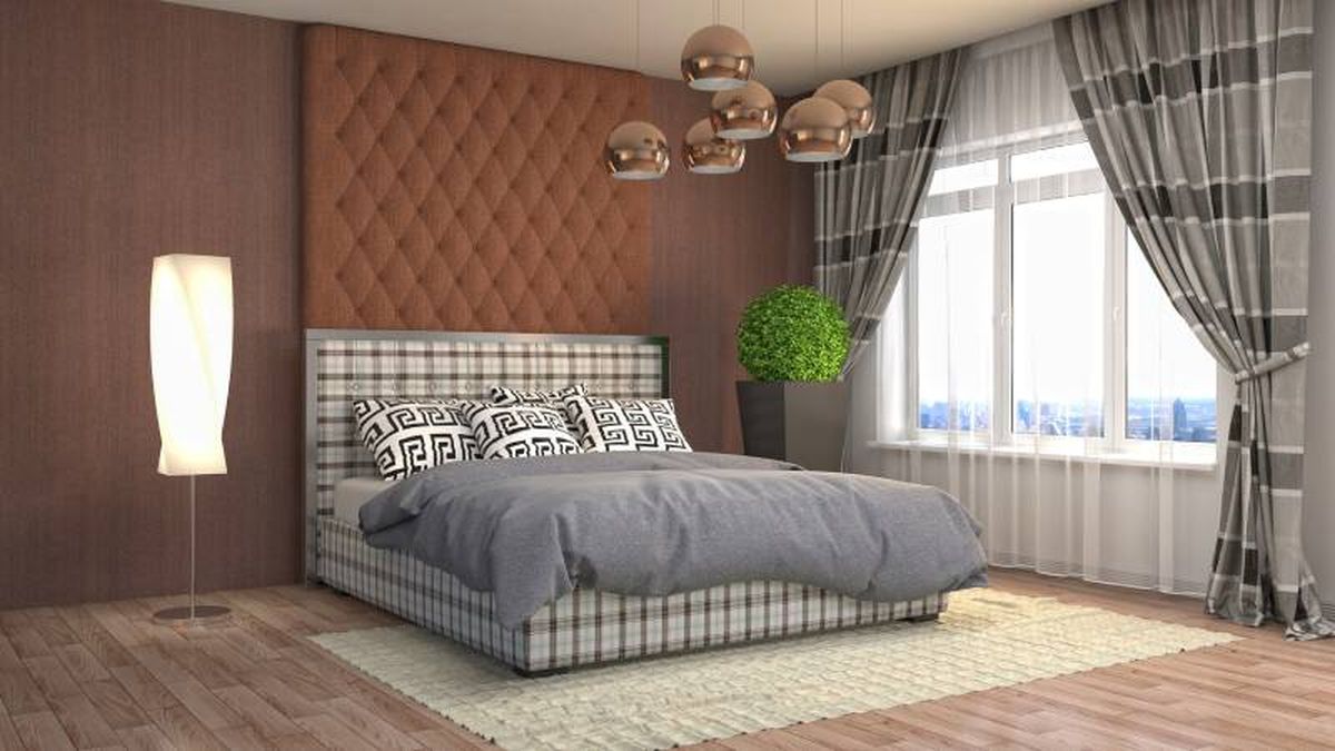 Dormitorio clásico con cabecero de cama tapizado.